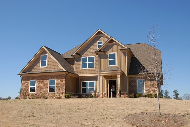 Large two-story home with tan and brick exterior.